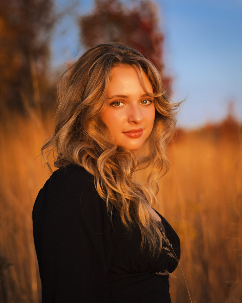 Family reviewing senior portrait artwork during an in-person reveal