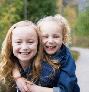 Two sisters hugging at Monon Central Park