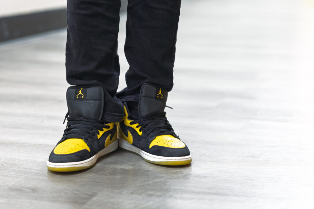 Howard Fuller Collegiate photography detail of student sneakers in school colors on the gym floor