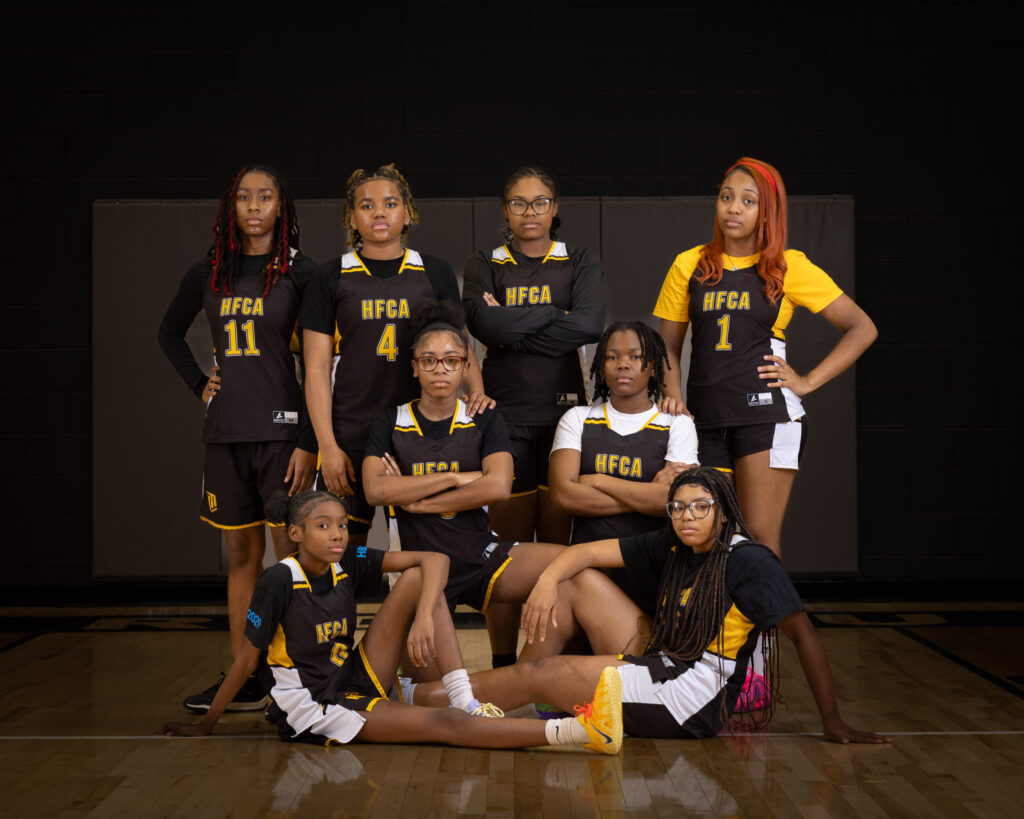 Howard Fuller Collegiate photography and charter school photography of the girls basketball team posed together in the school gym