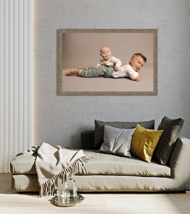 Large framed family canvas displayed above sofa in Carmel home