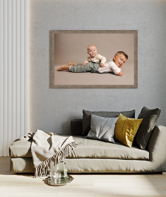 Large framed family canvas displayed above sofa in Carmel home