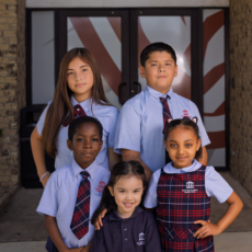 Students outside an entrance to Houston Classical Charter School