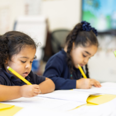 Elementary students working independently in classroom at Houston Classical